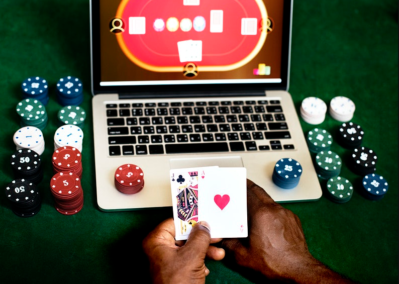 black man playing casino on laptop